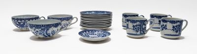 many blue and white cups and saucers on the table