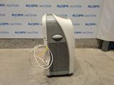 a small air conditioner sitting on the floor in front of a wall