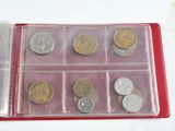 a red case with a bunch of coins inside of it