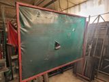 a picture of a room with a large green board in it