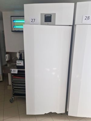 three refrigerators that are sitting in a room