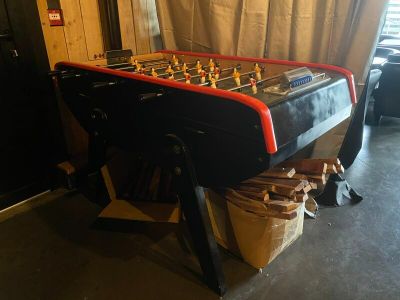 a foosball table in the corner of a room