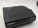 an image of a polaroid camera sitting on top of a white table