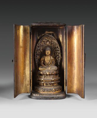 an image of a bronze statue of a buddha in a wooden case