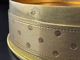 a close up of a gold ring on a black surface