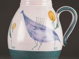 a blue and white vase with a bird painted on it