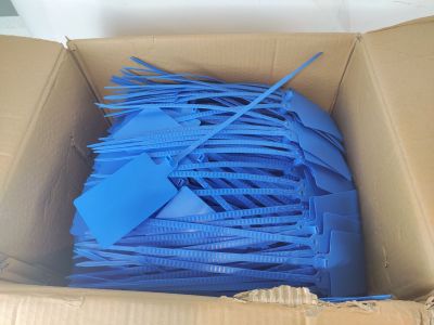 a cardboard box with a bunch of blue plastic straws in it