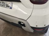 the rear end of a white car with a number plate on it