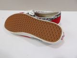 someone is wearing a pair of red and white shoes on a white surface