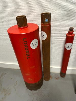 three red fire hydrants sitting next to each other on the floor