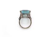 a close up of a ring with a blue stone in it