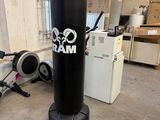 a black punching bag in the middle of a room