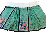 an image of a green skirt with blue and white flowers on it