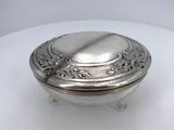 a silver box with a lid on a white surface