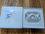 a box with an apple airpods in it on a wooden table