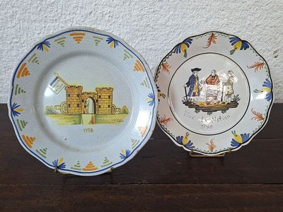 two plates that are sitting on a wooden table