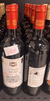 several bottles of wine are lined up on a shelf in a store
