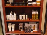 a wooden shelf with many bottles and containers on it