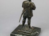 bronze figurine of a soldier with a rifle on a marble base