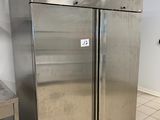two stainless steel refrigerators in a kitchen with tile flooring