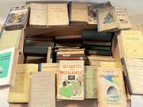 many books stacked on top of each other on a table