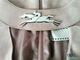 a picture of a horse brooch on the back of a dress