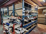 a large pile of assorted items on a shelf in a warehouse