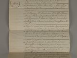 an old document with writing on it sitting on top of a table