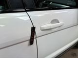 a close up of a car door handle with a sticker on it