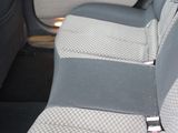 the back seats of a car with a seat belt in the back of it