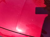 a red car that is parked on the side of the road