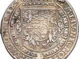 a close up of a silver coin with a coat of arms on it