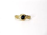 an image of a gold ring with a black stone on it
