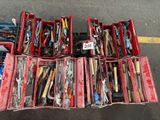 many different types of tools in a box on the ground
