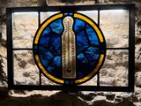 a stained glass window with a picture of a sword on it