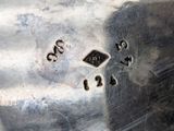 an antique silver plate with numbers on it sitting on top of a table