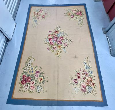 un tapis posé au sol sur lequel est représenté un bouquet de fleurs