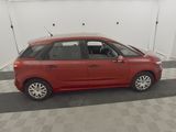 a red car is parked in a garage with a checkered floor