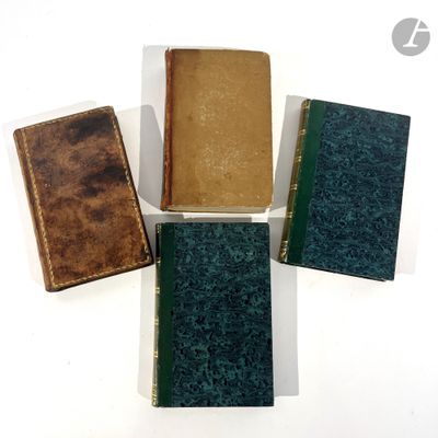 four books are lined up on a white surface, one is green and the other is brown