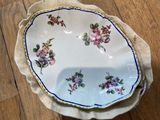 two plates with flowers on them on a wooden table