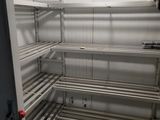 a very long metal shelf in the corner of a room
