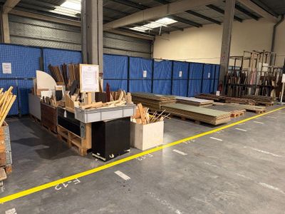 a large warehouse with a lot of wood on the floor