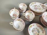a lot of plates and cups that are sitting on a table