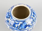 a blue and white vase sitting on a white surface