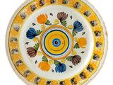 a yellow plate with blue and yellow flowers on it