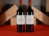 two bottles of wine sitting next to each other on a table