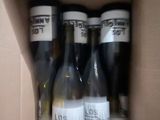 six bottles of wine in a box on the table