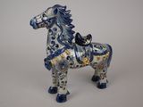 a blue and white horse figurine on a white surface