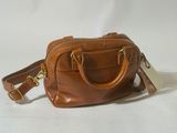 a brown leather handbag with two handles and a strap