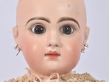 a close up of a doll wearing a dress and earrings